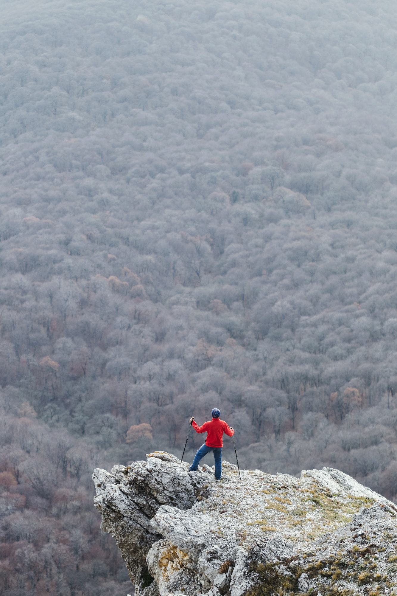 Man climbing to the edge of rock
